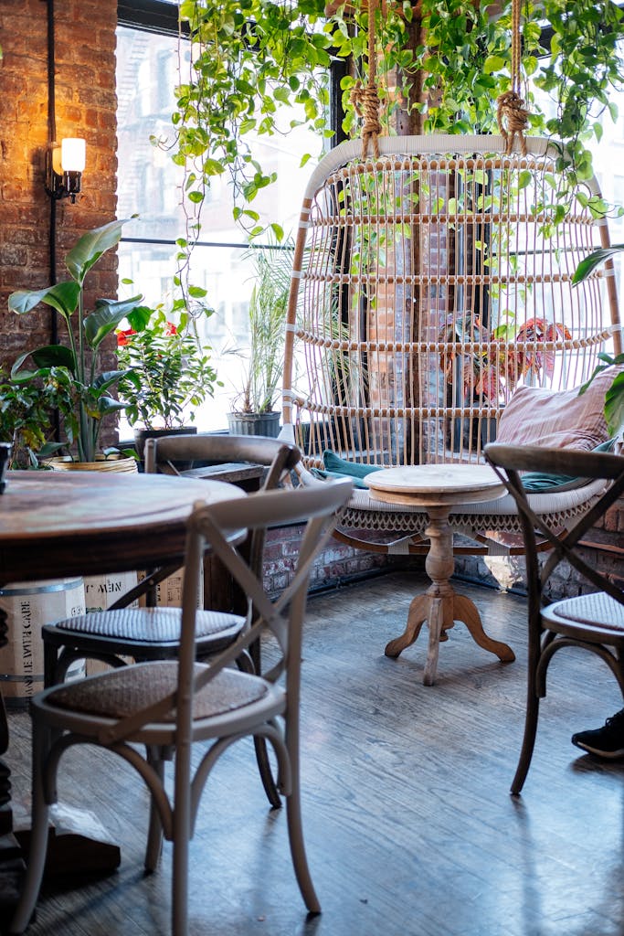 Charming rustic cafe interior featuring wooden seating and lush greenery for a homey ambiance.